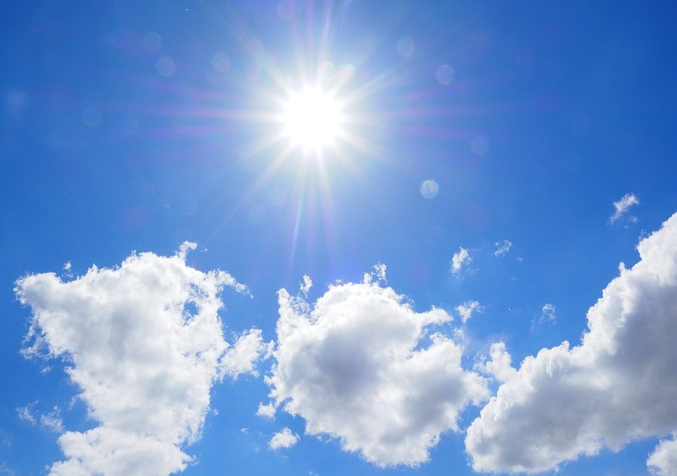 A sunny sky with a few clouds