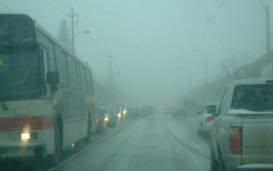 Vehicles in traffic as a snow squall comes through Toronto